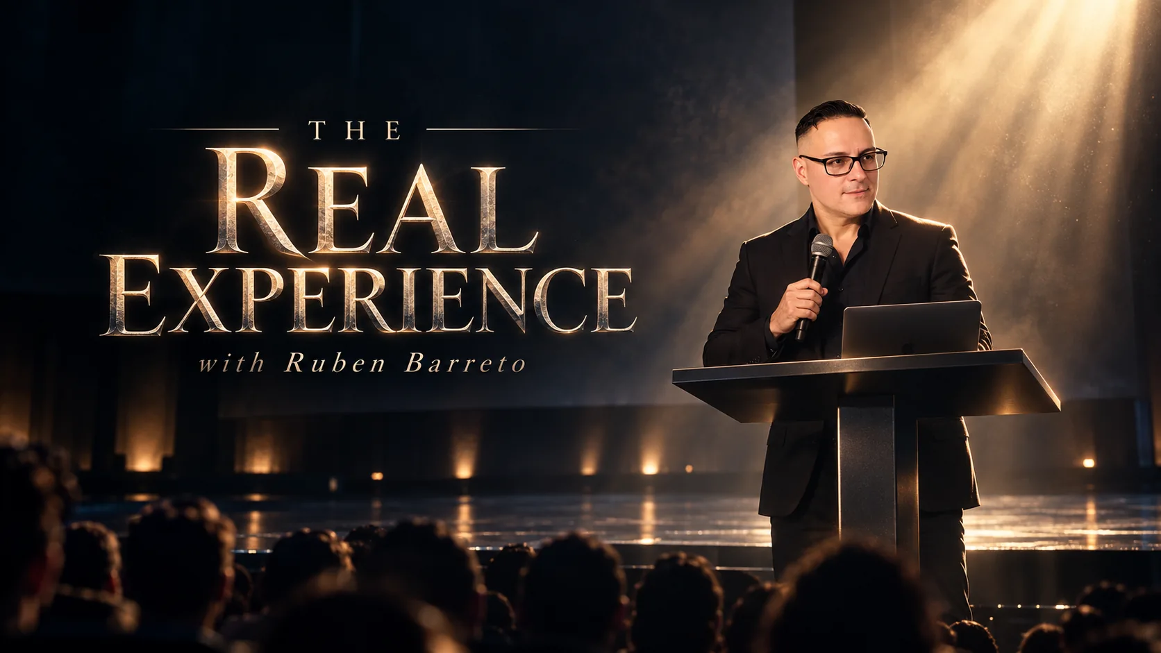 Ruben Barreto speaking under dramatic warm stage lighting